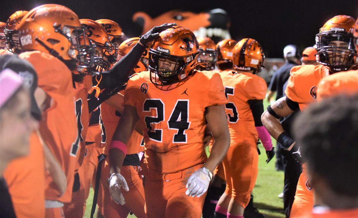 Merced High defensive lineman Malaki Leach (24) is congratulated on the Bears sideline after returning a fumble for a touchdown during a 56-14 win over Central Valley on Friday, Oct. 21, 2022 at Cathie Hostetler Stadium at Merced High School.