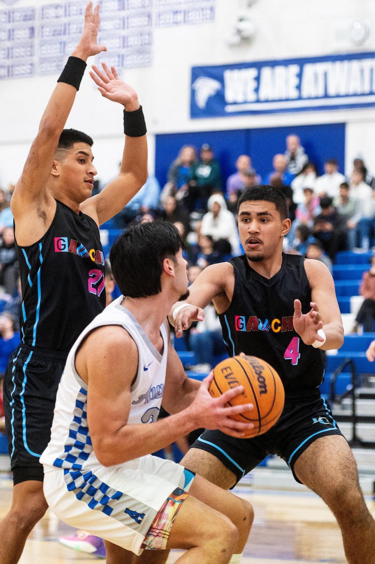 El Capitan junior Braylen Centeno (21) and El Capitan senior Raihan Wali (4) guard Atwater senior Fernando Torres Diaz (21) during a game at Atwater High School in Atwater, Calif., on Wednesday, Jan 17, 2024.