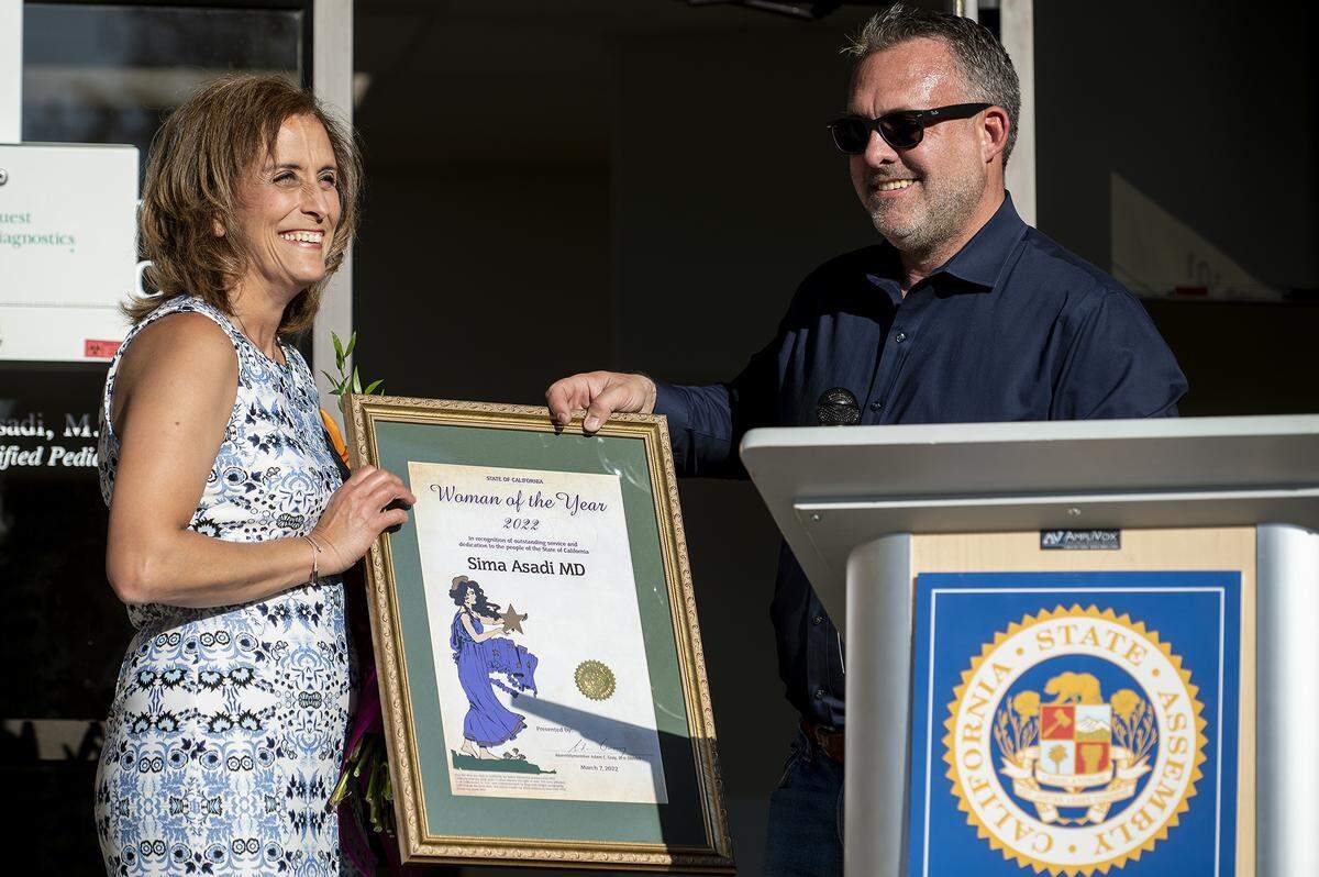 Assemblyman Adam Gray, right, recognizes Dr. Sima Asadi, left, as the California Woman of the Year for Assembly District 21, during a ceremony in Merced, Calif, on Tuesday, March 22, 2022.