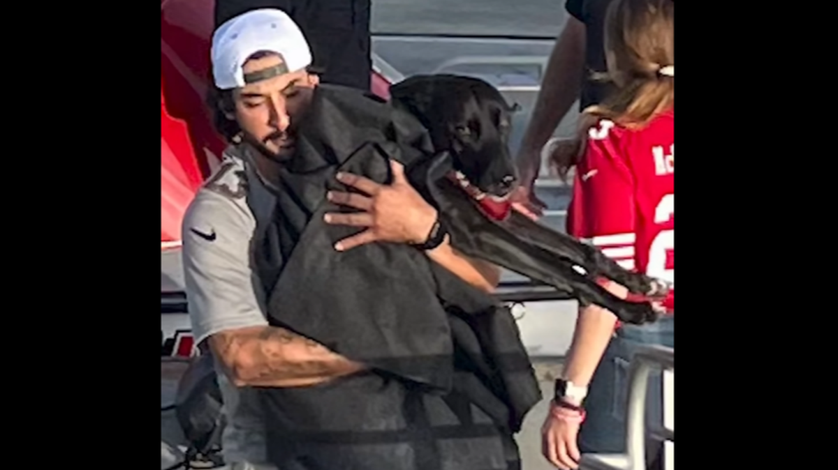 Brandon Valdez of Los Banos is seen carrying Sadie after the rescue in this screen shot image from a San Diego Fire-Rescue Department video.