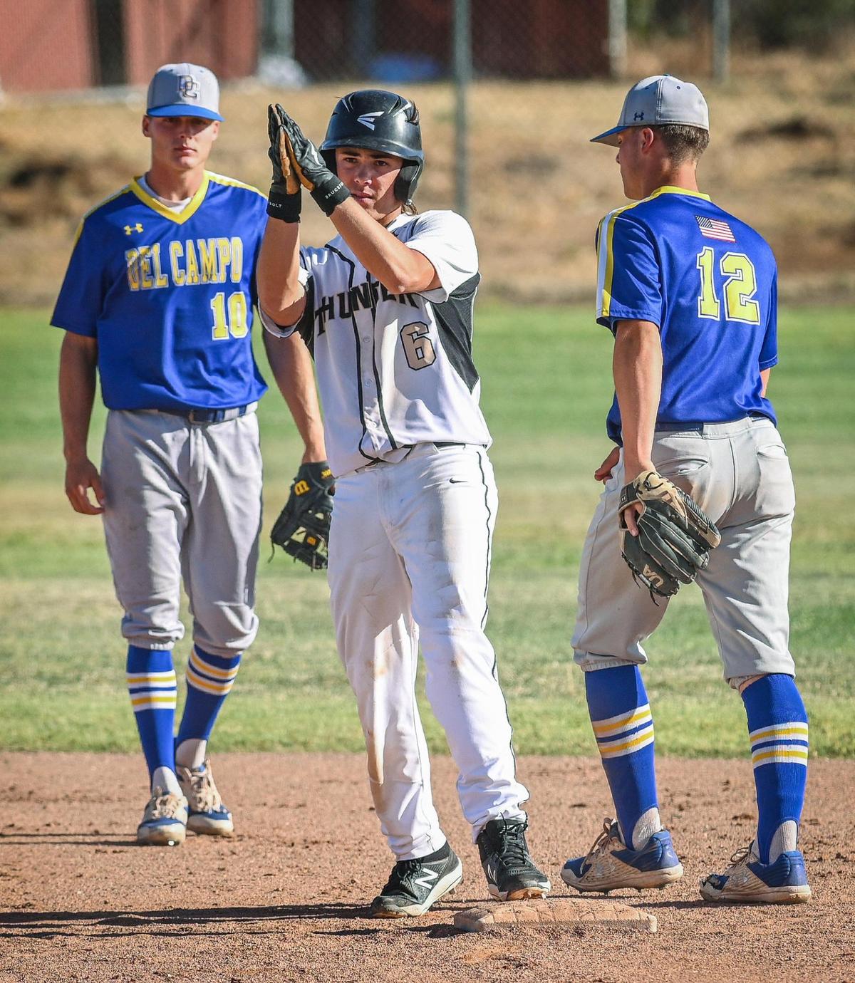 Buhach Colony’s Cooper Lanz, center, claps in the direction of the bench after stealing second during the Thunder’s playoff game against Del Campo at Buhach Colony in Atwater on Friday, May 20, 2022. At left is Del Campo’s Tyler Moore and Thomas Martinez, right.