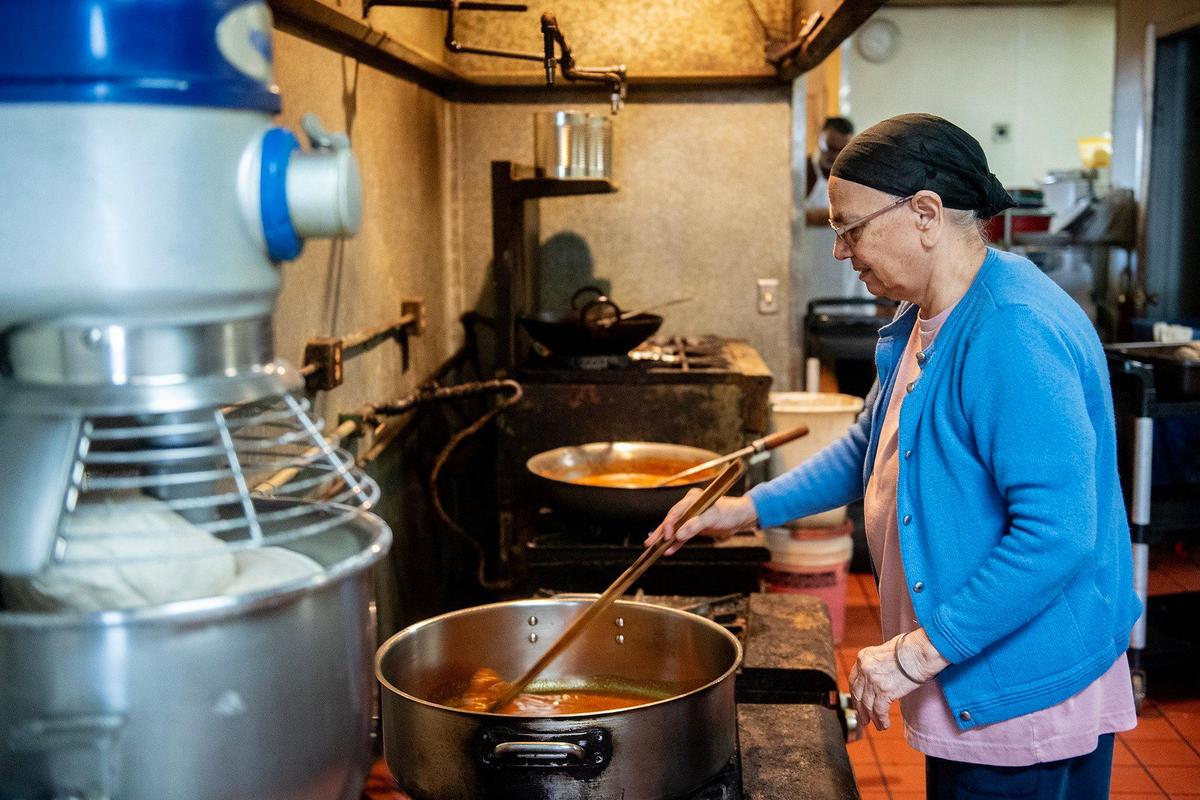 Jaswinder Samra, mother of Taste of Little India owner Parm Samra, prepares food for the buffet at the restaurant’s 1052 W. Main Street location in Merced, Calif., on Thursday, April 3, 2025. Parm Samra said he was informed that the building has changed ownership and his lease has been terminated. The restaurant will close on April 11.