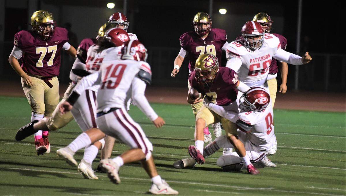Golden Valley quarterback Eleazar Garza injures his left ankle on this play in the first quarter. Garza’s left foot eventually gets trapped under Patterson defender Jaiden Jacob (8).
