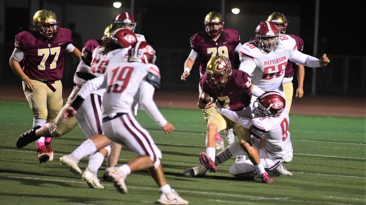 Golden Valley quarterback Eleazar Garza injures his left ankle on this play in the first quarter. Garza’s left foot eventually gets trapped under Patterson defender Jaiden Jacob (8).