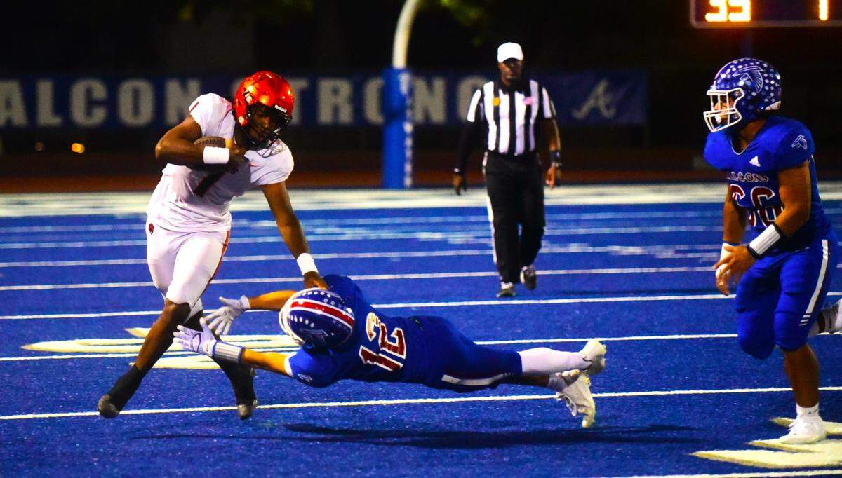 Merced High School quarterback Quintell Dupree (1) avoids an Atwater defender during the Bears’ 48-14 win over the Falcons in Santa Fe Bowl 53 on Friday, Sept. 22, 2023 at Dave Honey Stadium in Atwater, Calif.