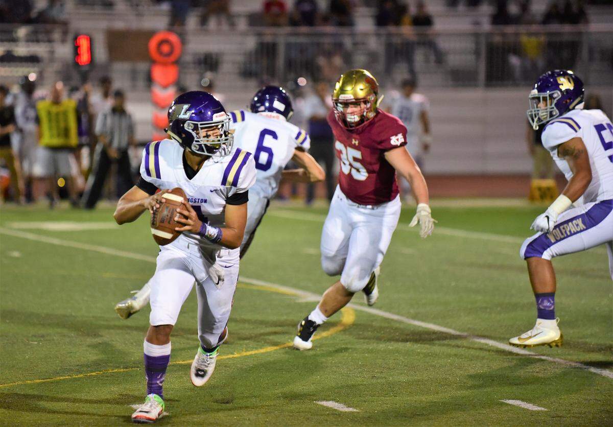Livingston sophomore quarterback Rocklin Baptista scrambles during a game against Golden Valley on Friday, Sept. 13, 2019 at Veterans Stadium.