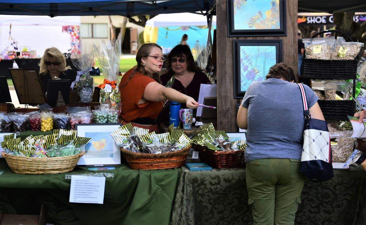 People shop at the 2022 Merced County Nut Festival at the Merced County Fairgrounds.