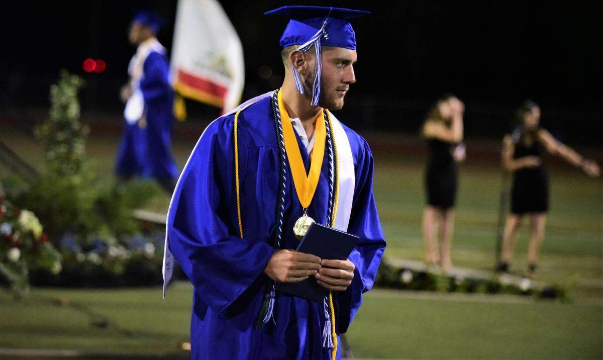 Atwater High School senior Bo Valladao receives his diploma during the Atwater High graduation ceremony on Thursday, June 2, 2022 at Dave Honey Stadium.