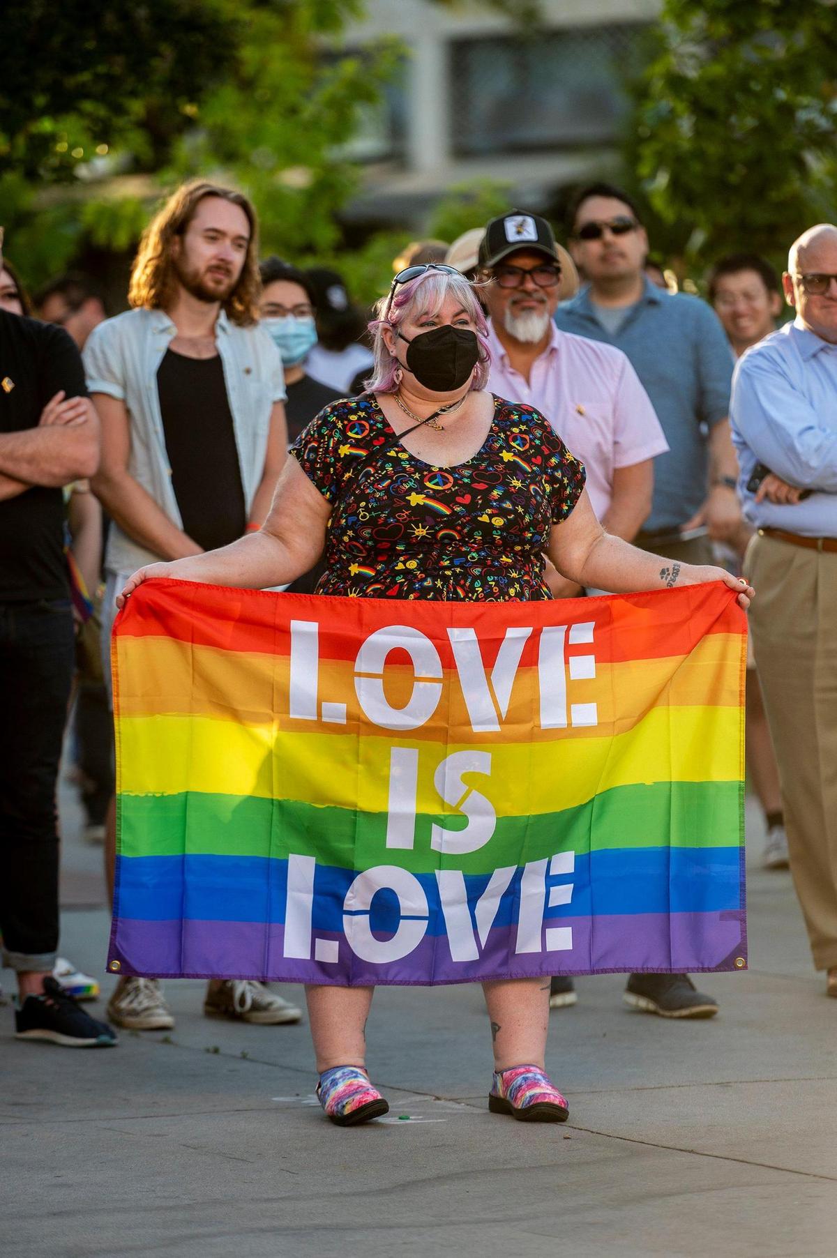 Community members look on during the Pride Progress flag raising ceremony at Bob Hart Square in Merced, Calif., on Wednesday, June 1, 2022. The Merced City Council approved the addition of the pride flag to the regular flag calendar, meaning the flag will fly over Bob Hart Square annually during the month of June.