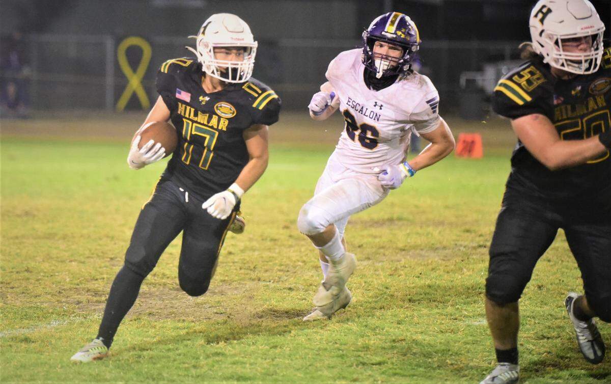 Hilmar High’s Jax Branco (17) runs the ball during a game against Escalon on Sept. 30, 2022 at Hilmar High School.