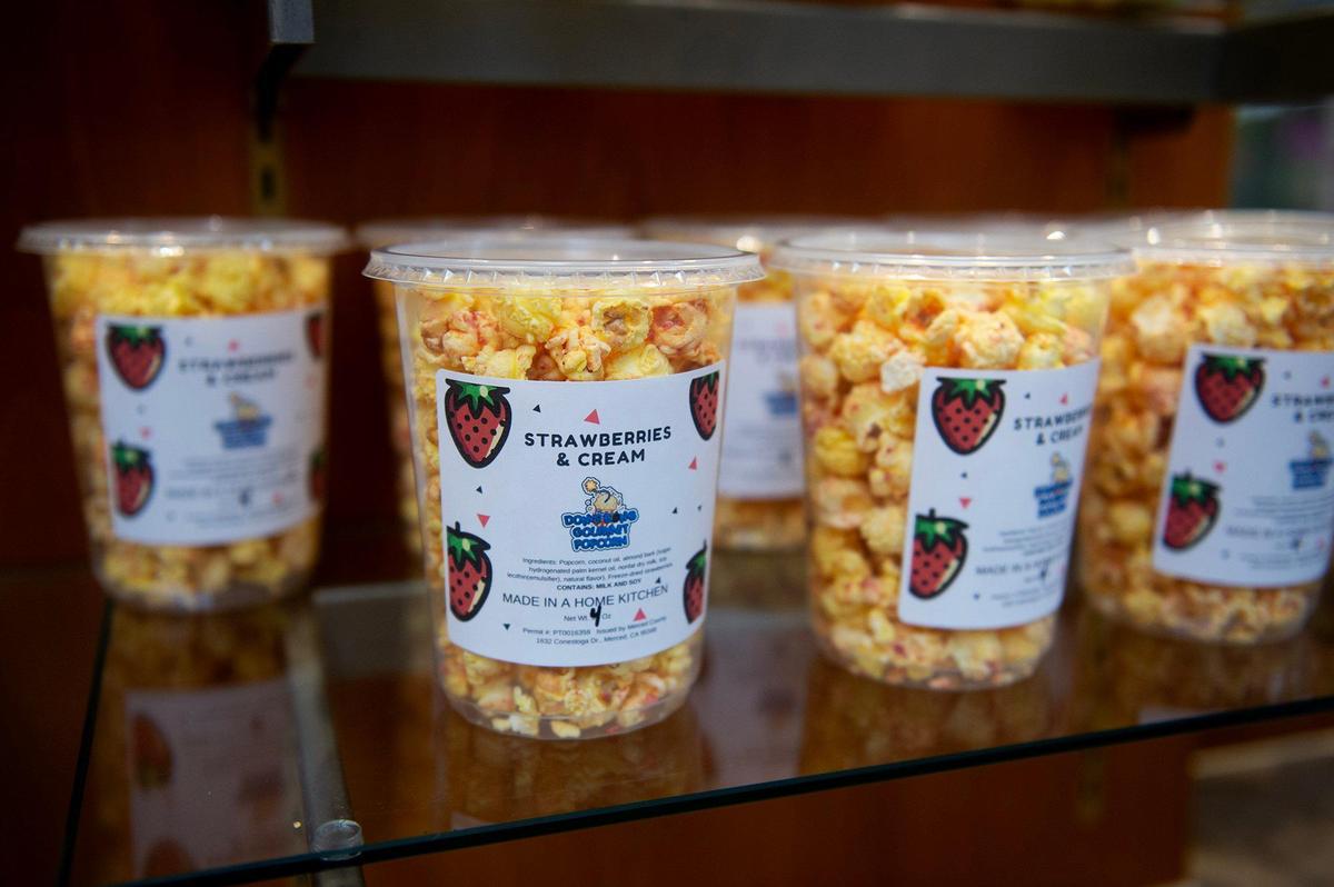 Various flavors of popcorn for sale during the grand opening of Dom’s Bomb Gourmet Popcorn inside the Marketplace at Merced in Merced, Calif., on Thursday, May 1, 2025. The kiosk offers unique gourmet popcorn flavors created by Merced resident Dominique Pruitt.