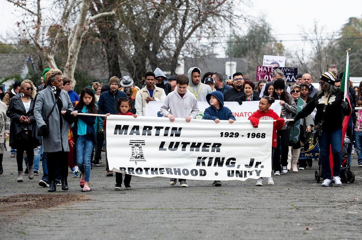 Marchers walk along Martin Luther King Jr. Way during the annual Peace and Unity March to honor the legacy of late civil rights leader Rev. Dr. Martin Luther King Jr. in Merced, Calif., on Monday, Jan 15, 2024.