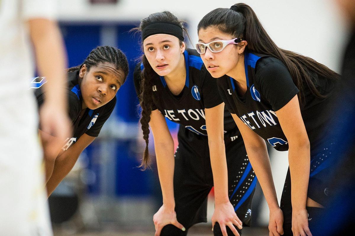 Atwater sophomore Amoni Claiborne (32), left, senior Lexi Valencia (11), center, and senior Marisa Martinez (3), right, talk things over during a Buhach Colony free-throw in a game at Atwater High School in Atwater, Calif., on Thursday, Jan. 17, 2019.