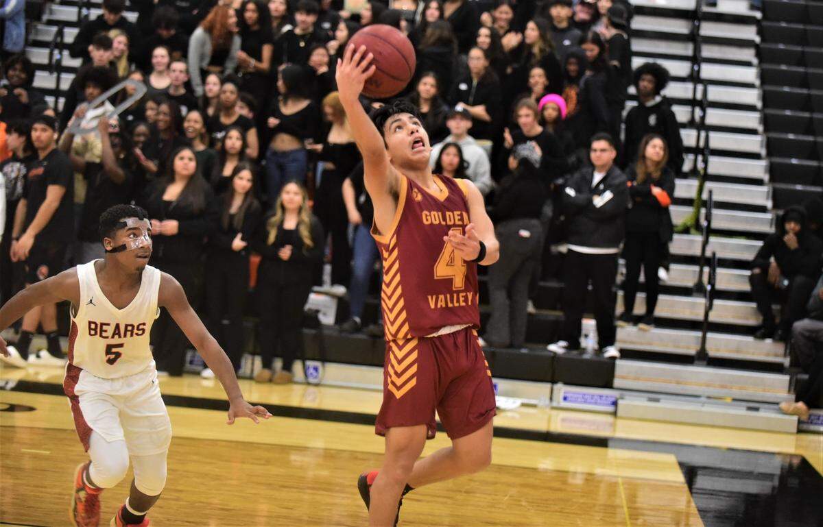 Golden Valley High School senior guard Drake Garza (4) goes up for a layup during a game against Merced on Vince Clemons Court at Merced High School on Friday, Jan. 20, 2023.