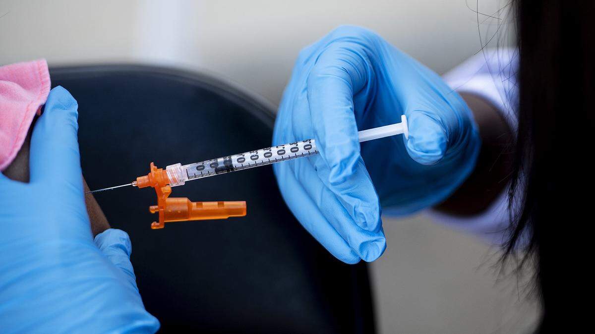 A vaccine is administered to a patient at a vaccination clinic at Frank Sparkes Elementary School in Winton, Calif., on Wednesday, Dec. 1, 2021.