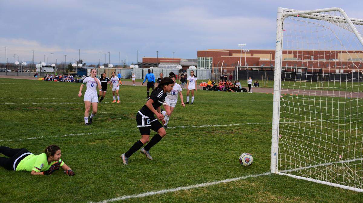El Capitan sophomore Anaya Shelton pounces on a goal after Kimball goalie Jordan Claire mishandles a free kick to tie the game at 1-1 in the first half of a playoff match on Friday, Feb. 21, 2020 at El Capitan High School.