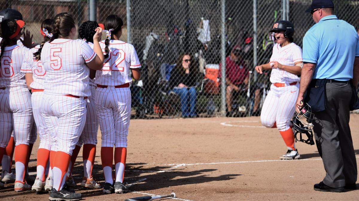 Merced High senior Ellie Alvarez is greeted at home plate by her teammates after hitting a home run in the first inning during a 4-3 win over Golden Valley on Thursday, March 31, 2022 at Merced High School.