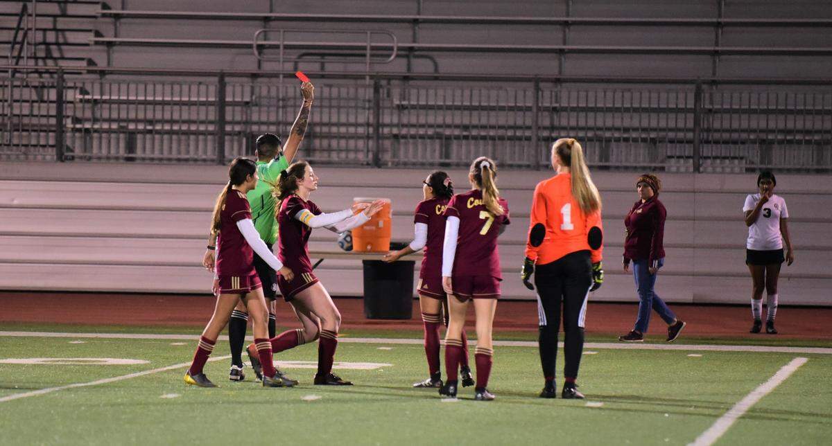 The referee hands a red card out to Golden Valley junior Cynthia Gutierrez after a fight had broke out moments earlier during a game against Merced on Thursday night at Veterans Stadium.