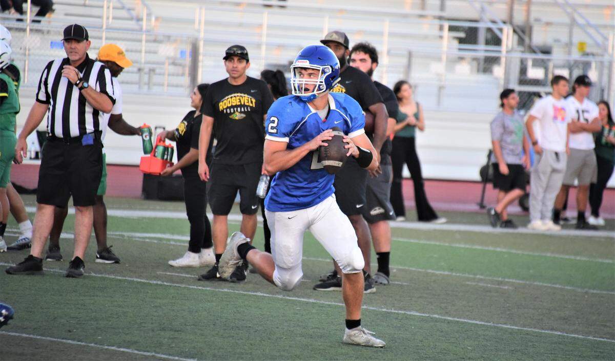 Atwater High School quarterback Tyler Parr scrambles with the ball during a scrimmage against Roosevelt High School on Friday, Aug. 12, 2022 at Dave Honey Stadium in Atwater, Calif.