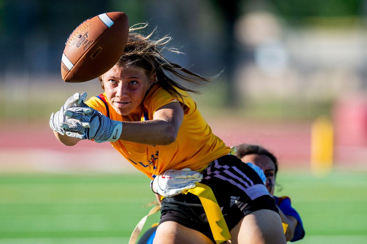 Gold All-Star Julianna Luchsinger (5) representing El Capitan, loses the ball as she is stopped by a Blue All-Star defender during the Merced County All-Star Girls Flag Football Game at Golden Valley High School in Merced, Calif., on Saturday, June 15, 2024. The Blue All-Stars beat the Gold All-Stars 20-12.