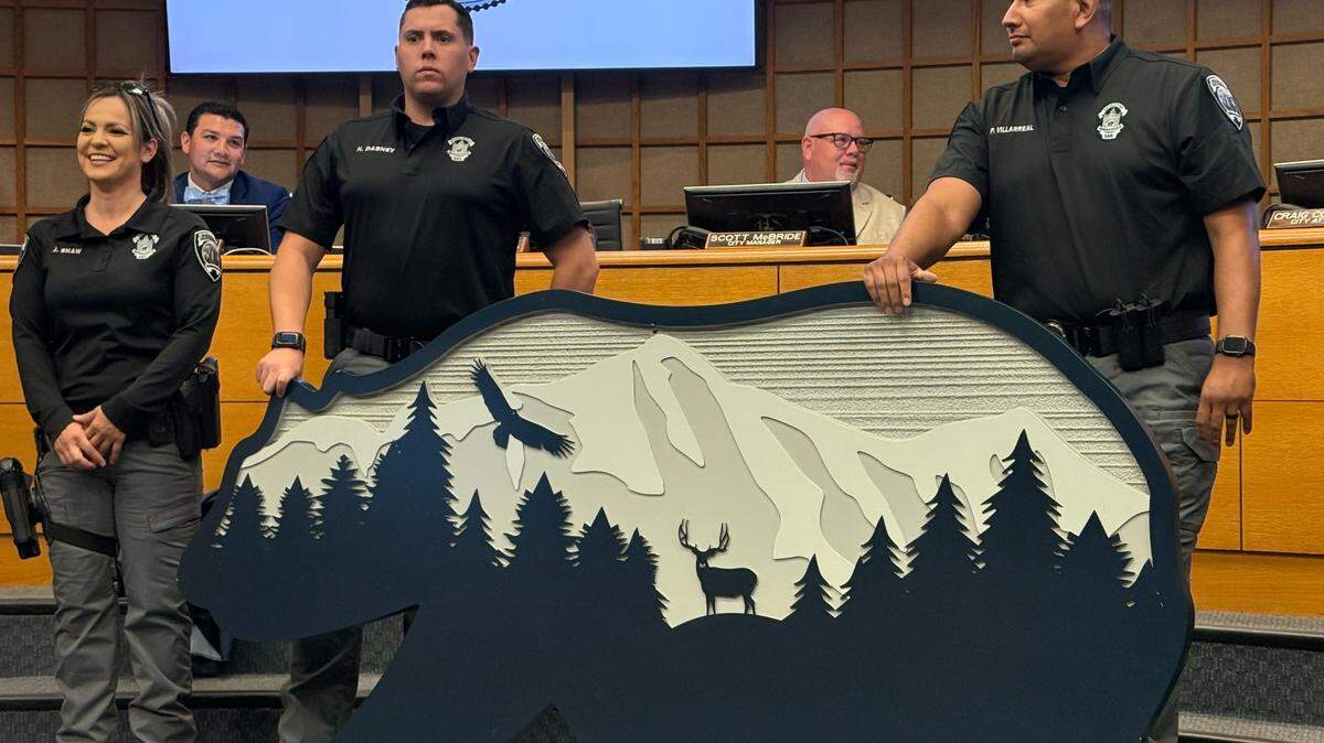 Detectives with the Merced Police Department pose with the recovered Applegate Zoo Bear sign on Aug. 4, which was recovered following a months long investigation.