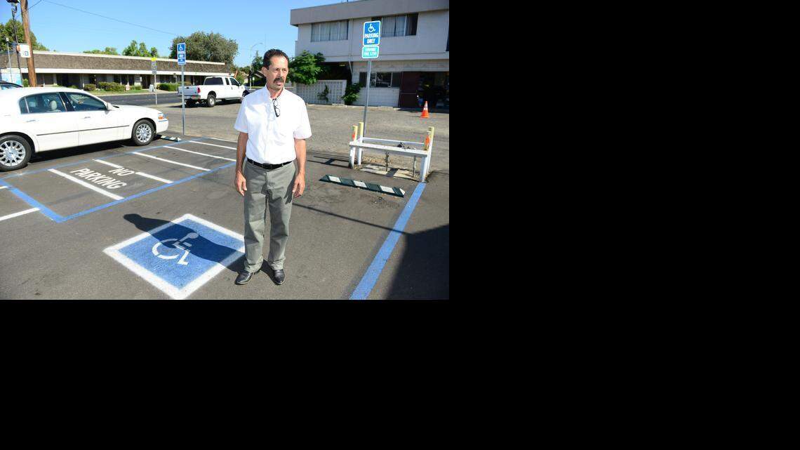 Bar B-Q Pit owner Roy Mercado stands in the parking lot of his restaurant on Wednesday. Inappropriate parking was one of the claims in an Americans with Disabilities Act lawsuit filed against Mercado.
