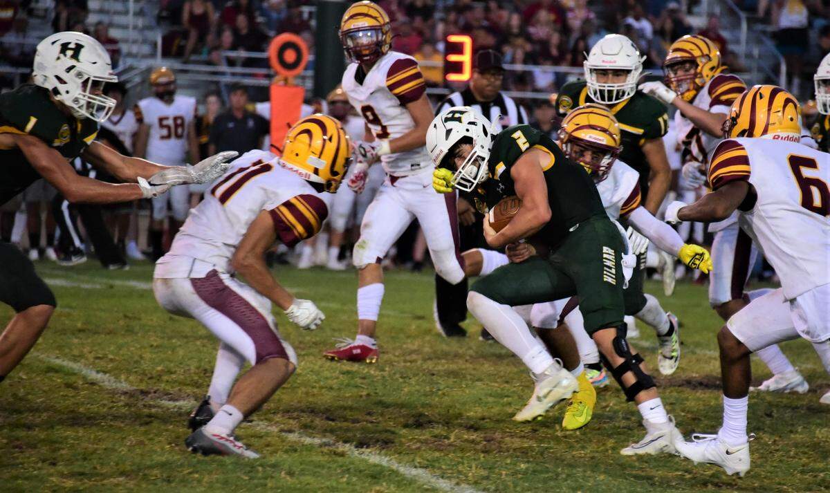 Hilmar High School quarterback Hudson Azevedo charges ahead against the Los Banos defense during the Yellowjackets’ 21-7 win over Los Banos on Friday, Aug. 26, 2022.