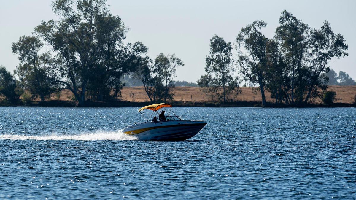 A boat skips across the surface of the water at Lake Yosemite in Merced, Calif., on Tuesday, Aug. 30, 2022.