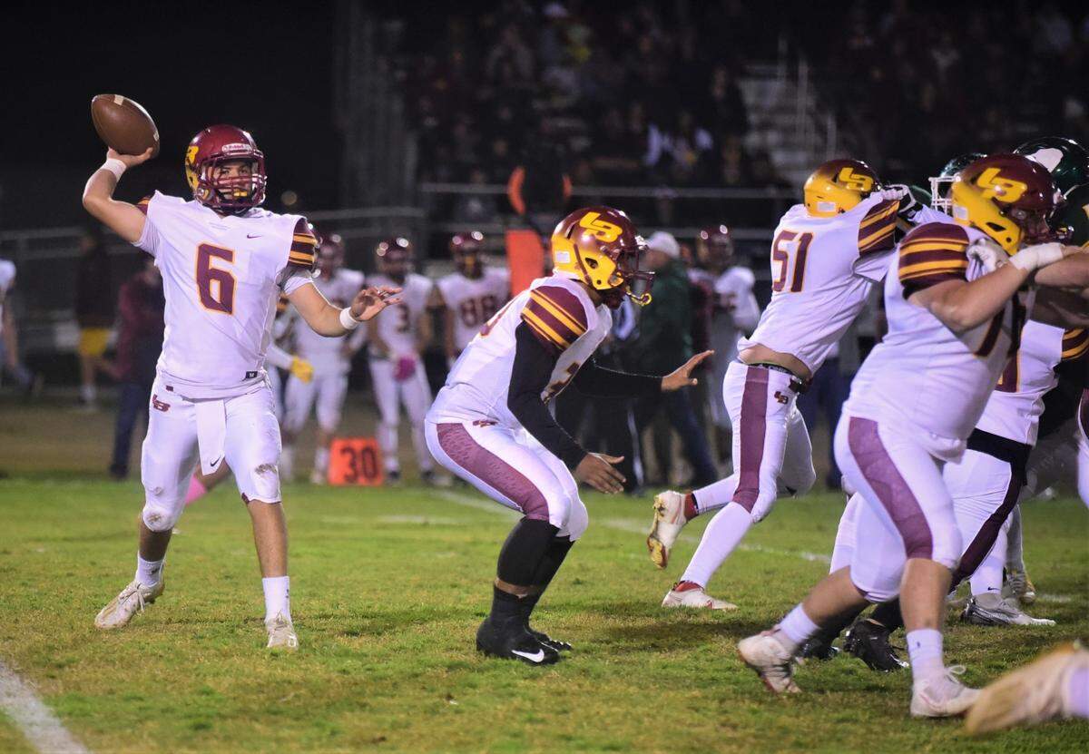 Los Banos quarterback David Herrera throws a pass during a playoff game against Hilmar on Friday, Nov. 5, 2021 at Hilmar High School.