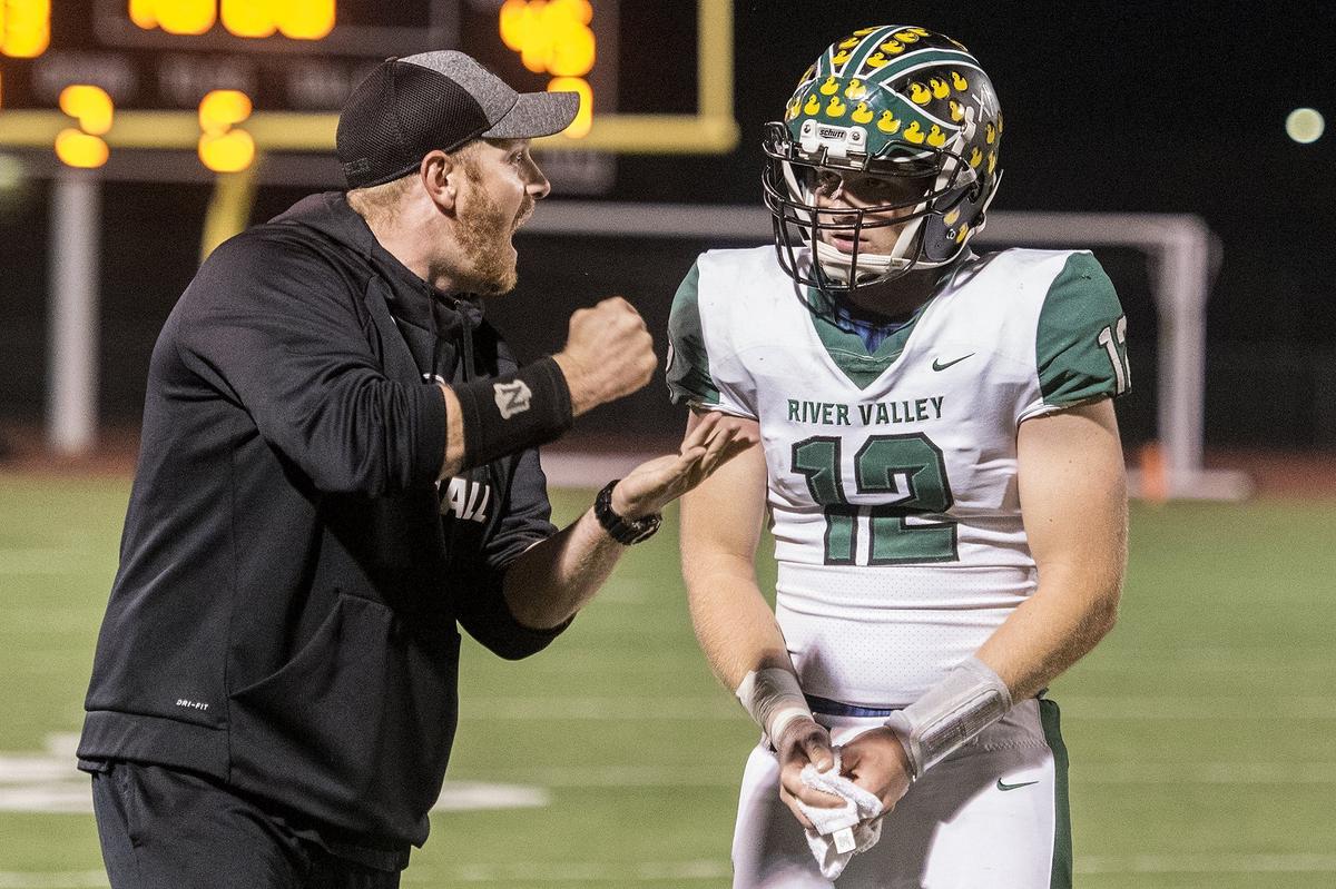 River Valley senior quarterback Dawson McPeak (12) speaks with head coach  Brennan McFaddenduring a CIF Sac-Joaquin Section Division III playoff game against Merced at Veterans Stadium in Merced, Calif., on Friday, Nov. 9, 2018. The Falcons beat the Bears 45-40.