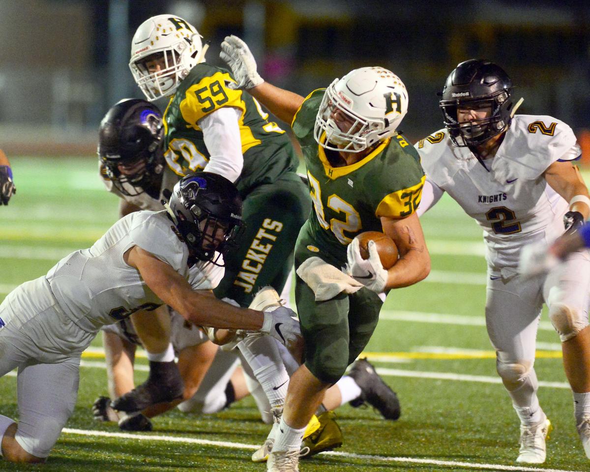 Hilmar’s Justin Rentfro (32) slips past two Ripon Christian defenders during the Division VI CIF Sac-Joaquin championship game between Ripon Christian and Hilmar at Turlock High School in Turlock CA on November 30, 2018.