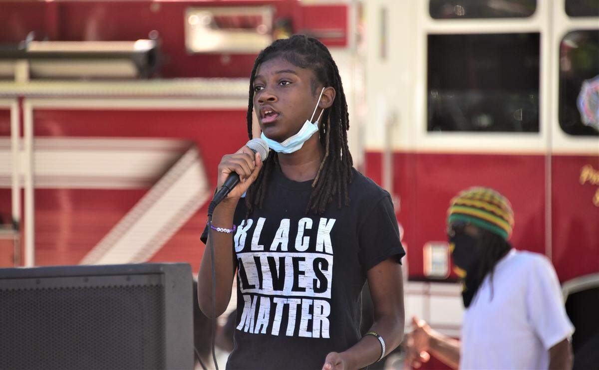 Judah Celeste, 13, of Dallas, Texas sings “Lift Every Voice and Sing” prior to the Juneteenth Parade in Merced, Calif. on Saturday, June 18, 2022.