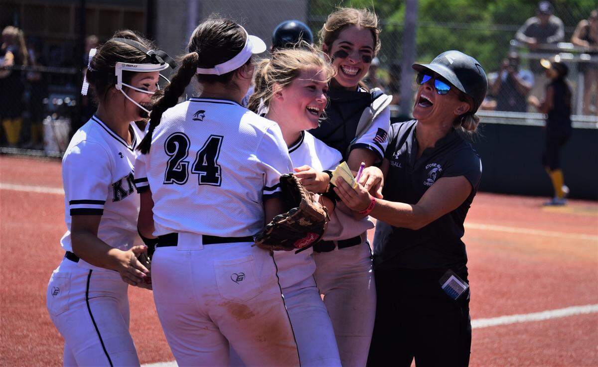 Stone Ridge Christian players and head coach Cathy Cole (right) celebrate a big double play that ended the sixth inning during the Sac-Joaquin Section Division VII championship game against Big Valley Christian on Saturday, May 21, 2022 at the San Joaquin Delta Softball Complex in Stockton, Calif.
