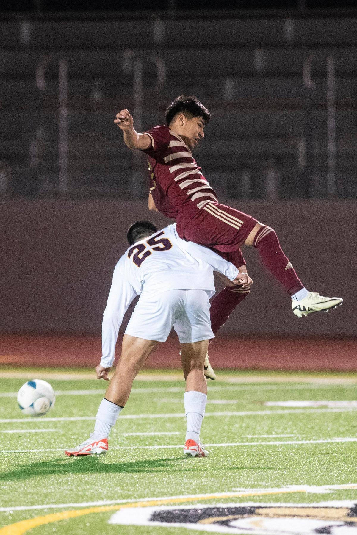 Golden Valley junior Jose Ontiveros (24) is upended by Las Lomas’ Jesse Li (25) during a NorCal Regional playoff game at Golden Valley High School in Merced, Calif., on Tuesday, Feb. 27, 2024. The Knights beat the Cougars 3-1 in penalty kicks.