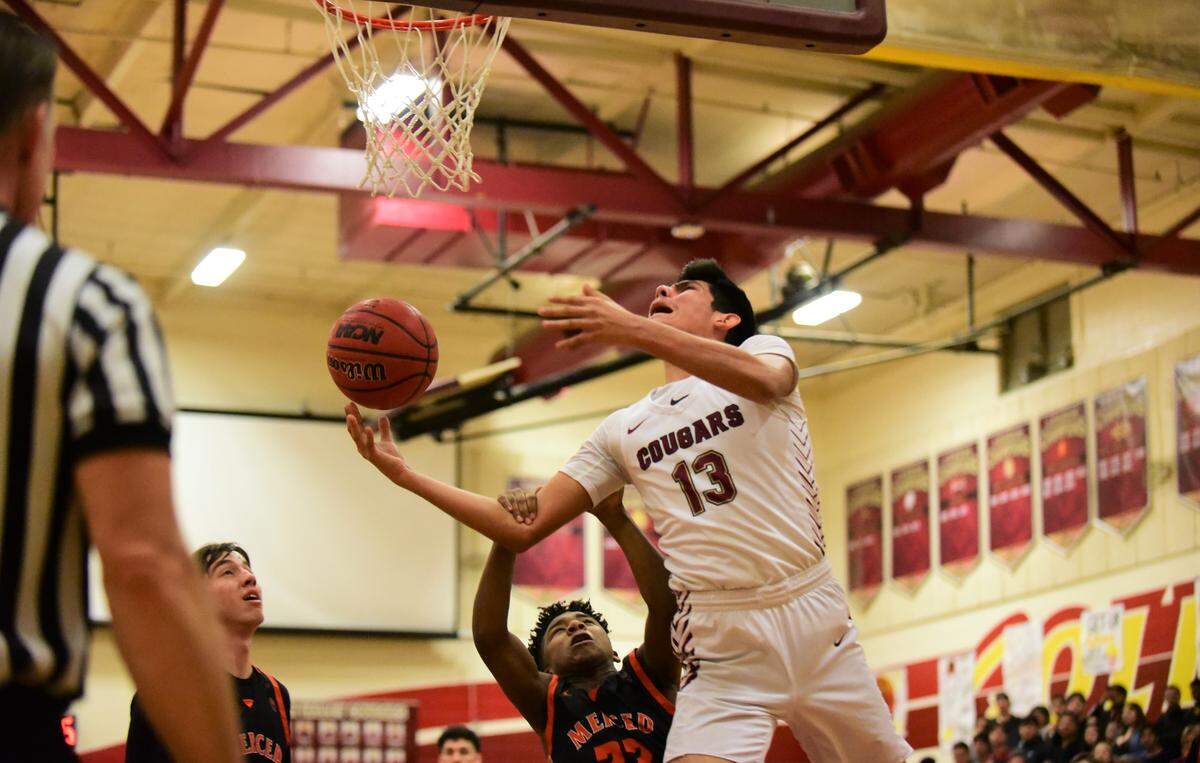 Golden Valley junior Anthony Vendez is fouled by Merced’s Koen Tyler during a game on Friday, Feb. 14, 2020 at Cougar Arena.