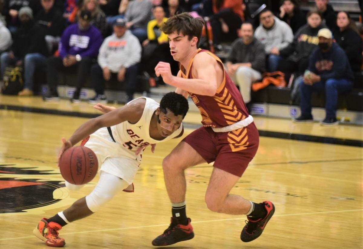 Merced High School senior Koen Tyler (5) drives around Golden Valley’s Joseph Spielman during a game on Vince Clemons Court at Merced High School on Friday, Jan. 20, 2023.