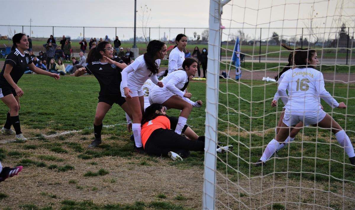 El Capitan freshman Kimberly Roman (center) reacts and several Golden Valley watch as Roman’s shots goes into the net to tie the match at 1-1 early in the second half during a match on Friday, January 7, 2022 at El Capitan High School in Merced, Calif.