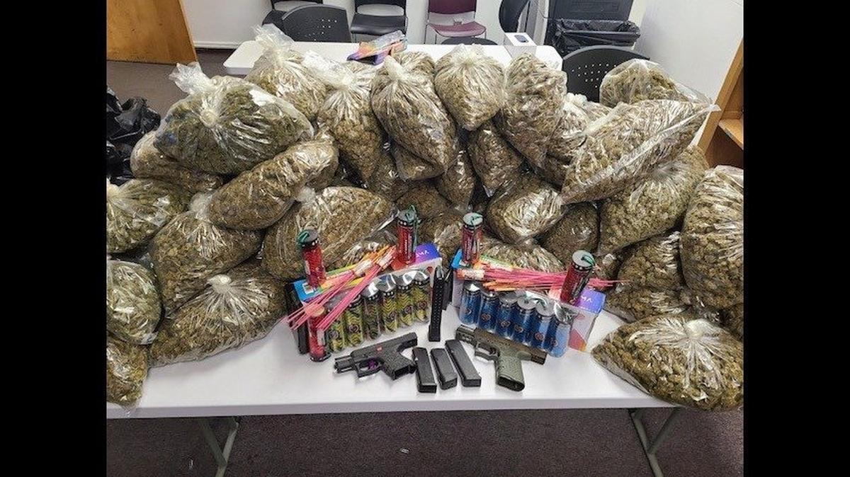 Two suspects were arrested when officers located more than 70 pounds of marijuana, two guns and illegal fireworks while serving a search warrant at a Merced home on Monday, according to the Merced Police Department. Image courtesy of Merced Police Department.