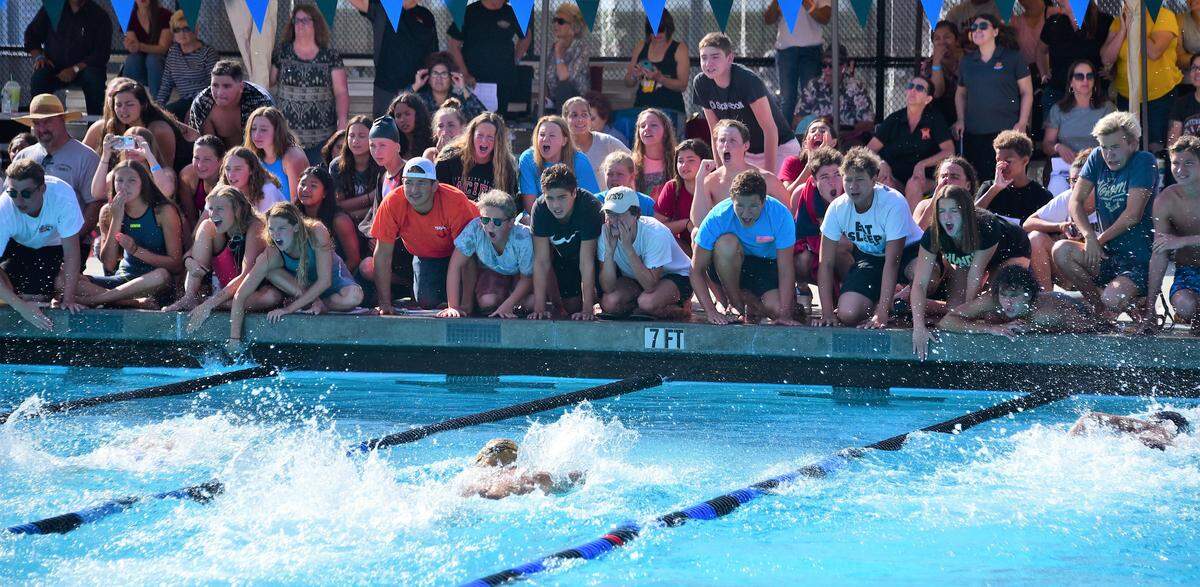 Teammates cheer on swimmers during the final event at the Central California Conference championships at El Capitan High in Merced, Calif. on Thursday, April 18, 2019.