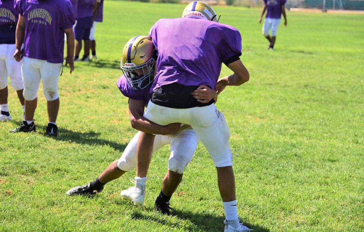 Livingston High School junior Zack Duran participates in a tackling drill during practice on Tuesday, Aug. 1, 2023 at Livingston High School.