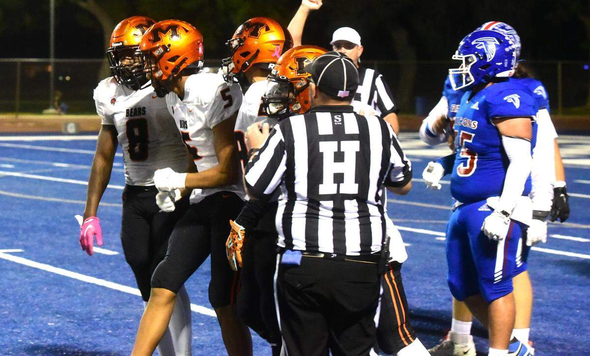 Merced High defensive players celebrate with Bears defensive end Jatavious Lewis after the senior records a sack in the first half of Santa Fe Bowl 44 against Atwater on Friday, Oct. 26, 2024 at Dave Honey Stadium.