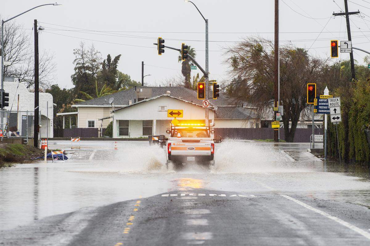 A Caltrans vehicle drives through flooded section of Childs Avenue between G Street and Highway 59 in Merced, Calif., on Monday, Jan. 9, 2023.