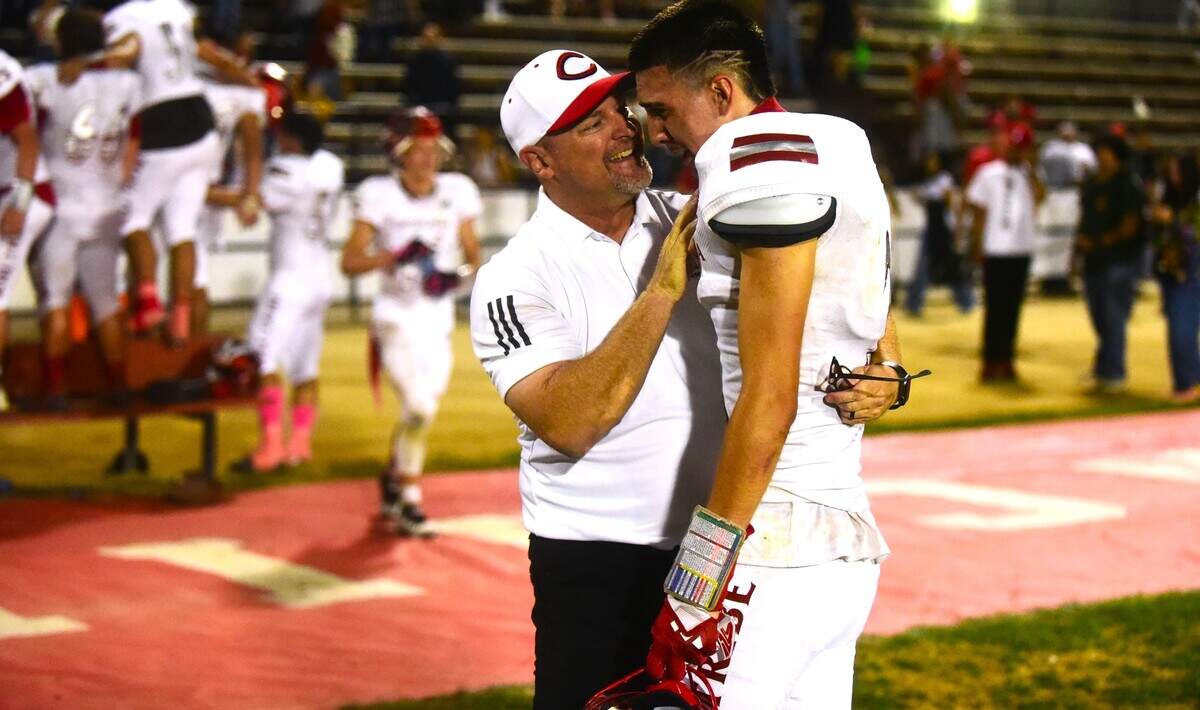Chowchilla High School head football coach Alex Pittz (left) shares a moment with senior receiver Anthony Avial after the Tribe defeated Caruthers 32-21 in a thrilling last-second victory on Friday, Oct. 20, 2023 in Chowchilla, Calif.