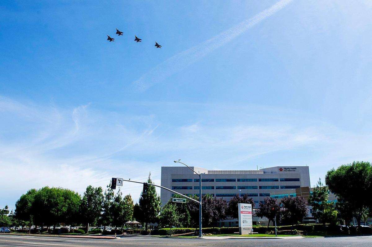 Four F-15C Eagle Tactical Fighter Jets with the 144th Fighter Wing out of Fresno, perform a flyover outside Mercy Medical Center in Merced, Calif., on Wednesday, May 13, 2020.