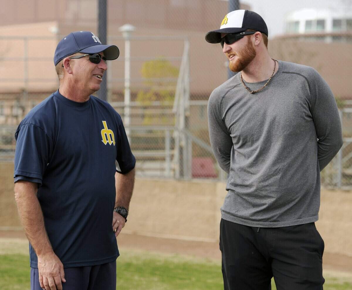 Merced College's Chris Pedretti chats with former Merced College pitcher Curtis Partch, who made it to the Major Leagues with the Cincinnati Reds and Pittsburgh Pirates, during practice in Merced Thursday. (1-23-14)