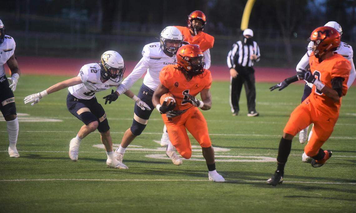 Merced High running back Cody Chapman (1) heads up field against Central Catholic during a game on Thursday, March 25, 2021.