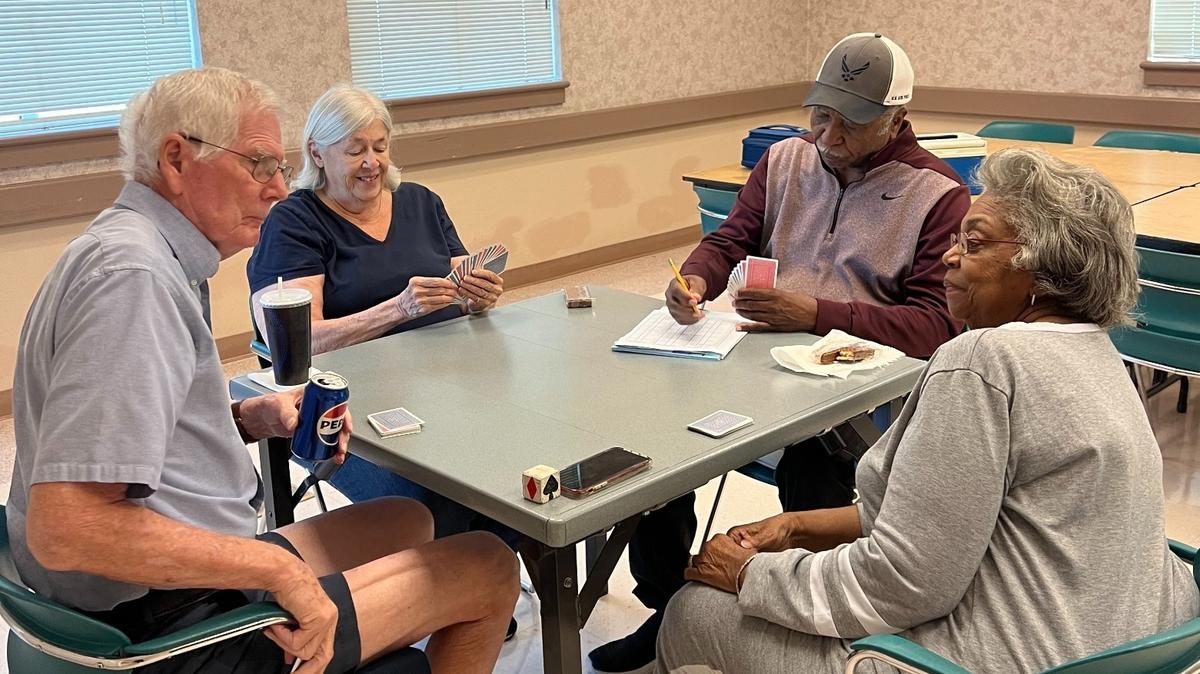 Polly Spires (front right), 80, plays the card game, Pinochle with her friends at the Merced Senior Community Center on Thursday Oct. 18, 2024. She visits the center three times a week to socialize with people in her age group. “I live alone. It’s the only time I get to talk to anyone,” Spires said. The senior center is facing displacement when construction of the high-speed rail begins in Merced in 2026.