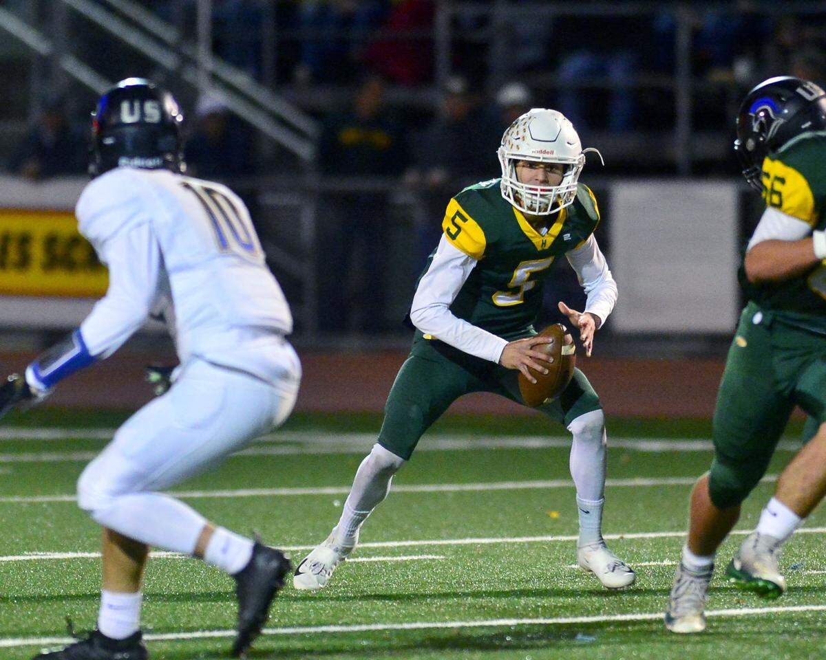 Hilmar quarterback Treven Crowley (5) reacts to a defender on an option play during the Division VI CIF Sac-Joaquin championship game between Ripon Christian and Hilmar at Turlock High School in Turlock CA on November 30, 2018.