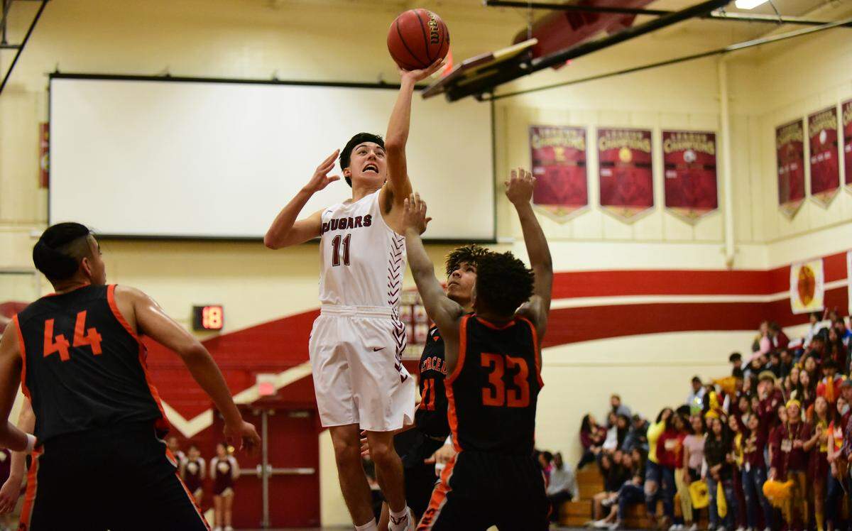 Golden Valley senior Zack Fernandez goes up for a shot against Merced during a game on Friday, Feb. 14, 2020 at Cougar Arena.