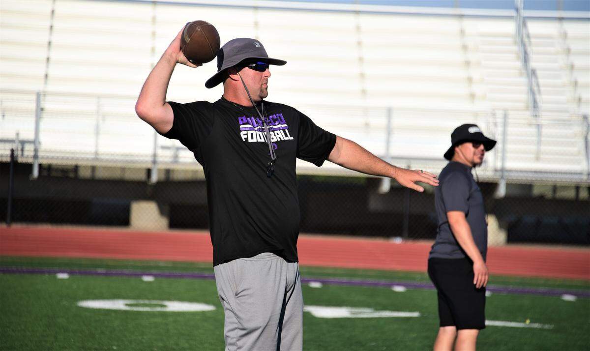 Pacheco High School head coach Jeremy Siemiller throws a pass during practice on Wednesday, Aug. 3, 2022 at Pacheco High School in Los Banos, Calif.